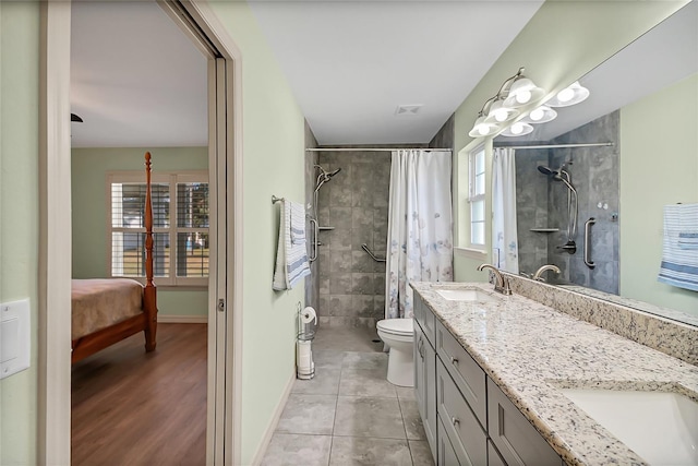 bathroom with tile patterned flooring, plenty of natural light, walk in shower, and vanity