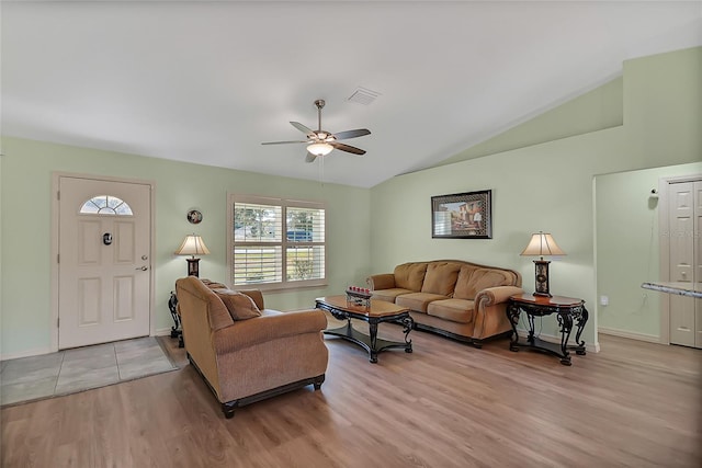 living room featuring light wood-type flooring, vaulted ceiling, and ceiling fan