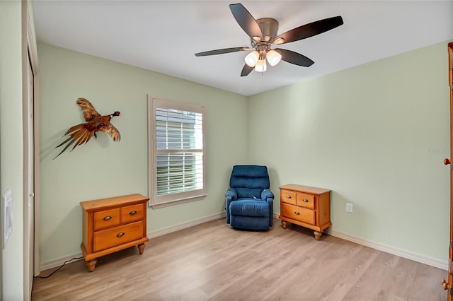 sitting room featuring ceiling fan and light hardwood / wood-style flooring