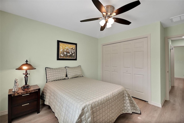 bedroom featuring light wood-type flooring, a closet, and ceiling fan