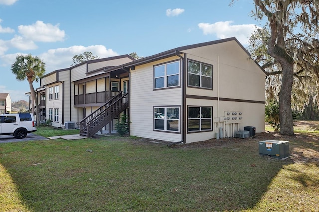 exterior space with central AC and a front lawn