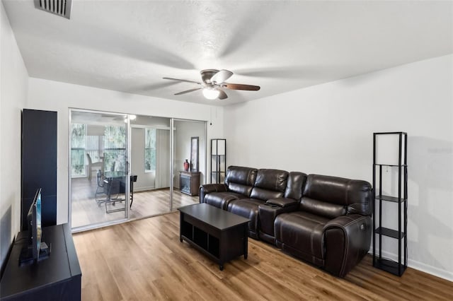 living room with ceiling fan and hardwood / wood-style flooring