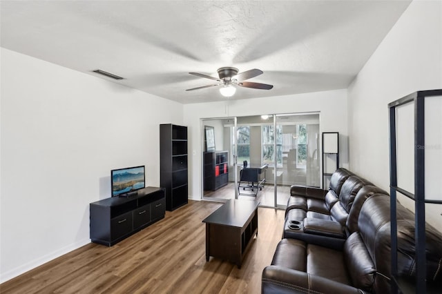 living room featuring hardwood / wood-style flooring and ceiling fan