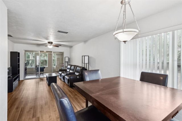 dining room with ceiling fan and wood-type flooring