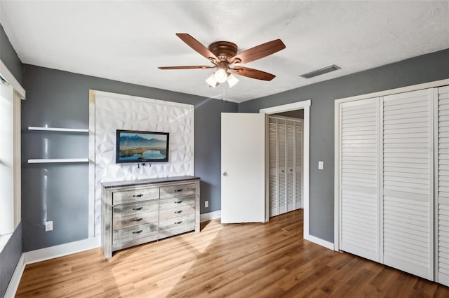 unfurnished bedroom with ceiling fan and hardwood / wood-style flooring