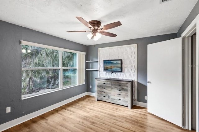 unfurnished bedroom featuring ceiling fan and light hardwood / wood-style flooring