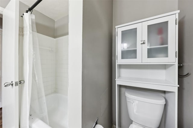 bathroom with toilet and shower / bathtub combination with curtain