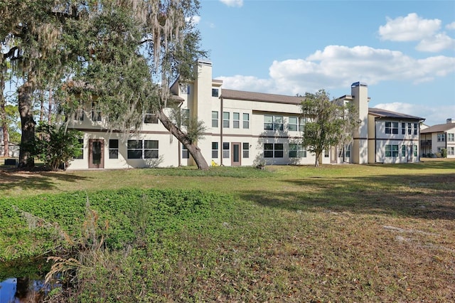 rear view of property featuring a yard