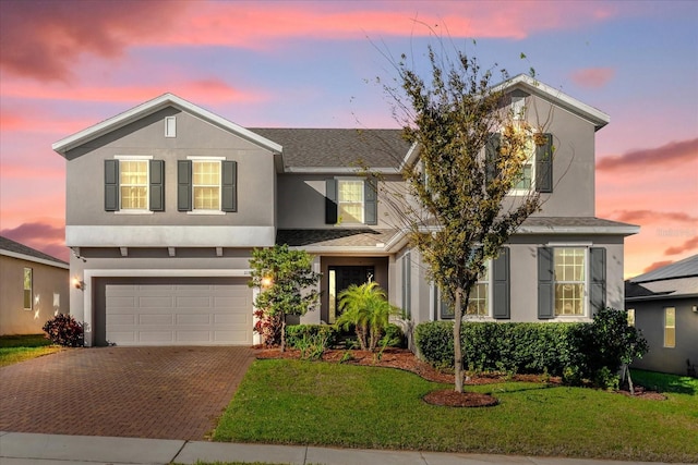 view of front facade featuring a lawn and a garage