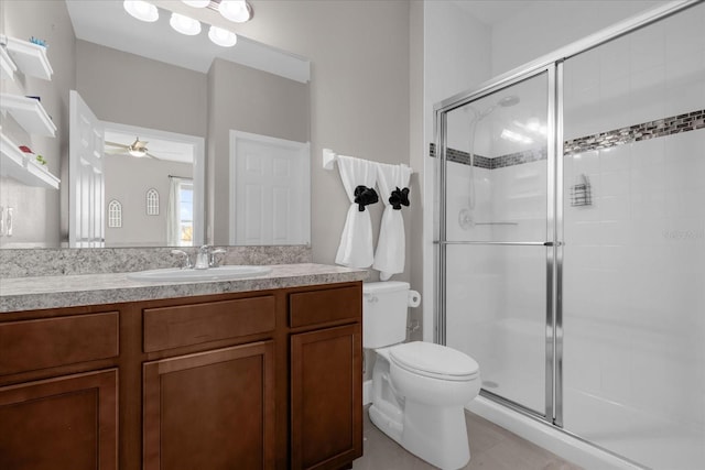 bathroom featuring vanity, ceiling fan, toilet, and walk in shower