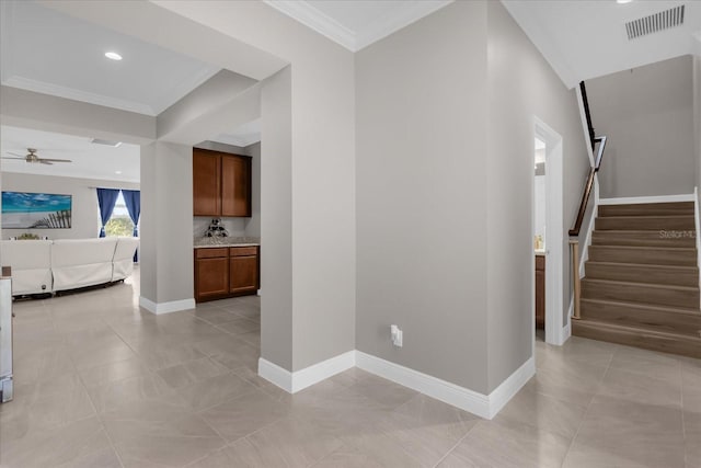 hallway featuring light tile patterned floors and crown molding