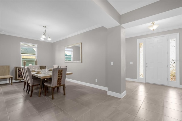 dining area featuring a notable chandelier, light tile patterned flooring, and ornamental molding