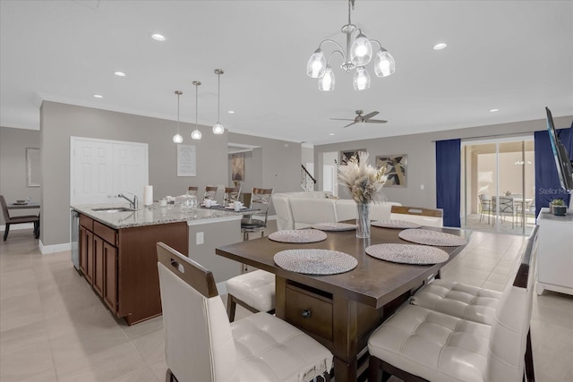 dining room with sink, light tile patterned flooring, and ceiling fan with notable chandelier