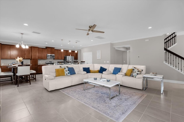 living room with crown molding, light tile patterned floors, and ceiling fan with notable chandelier