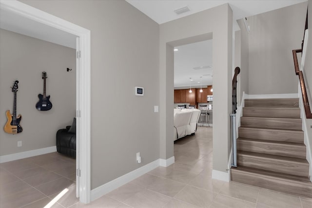 stairs featuring tile patterned flooring