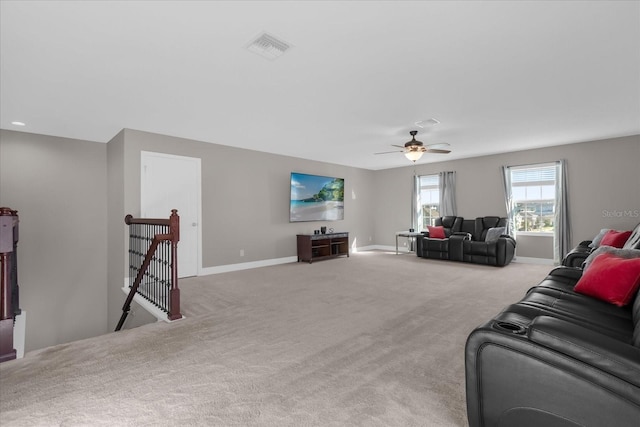 living room featuring ceiling fan and light colored carpet