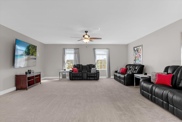 carpeted living room with ceiling fan