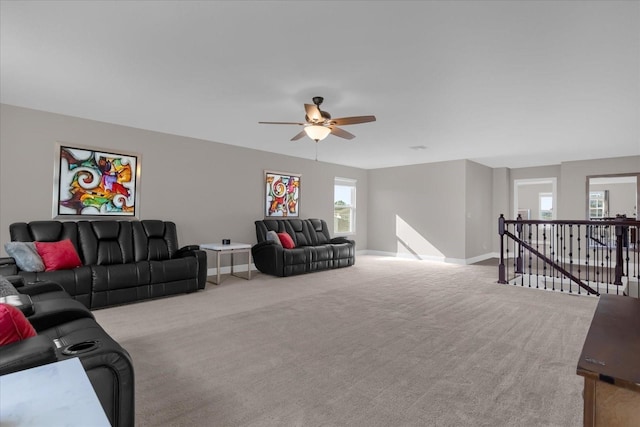 carpeted living room with ceiling fan