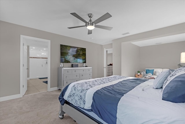 carpeted bedroom featuring ceiling fan and ensuite bathroom