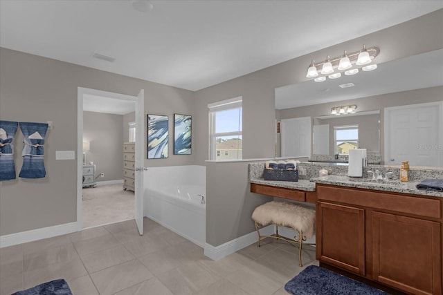 bathroom with tile patterned floors, vanity, and a bath