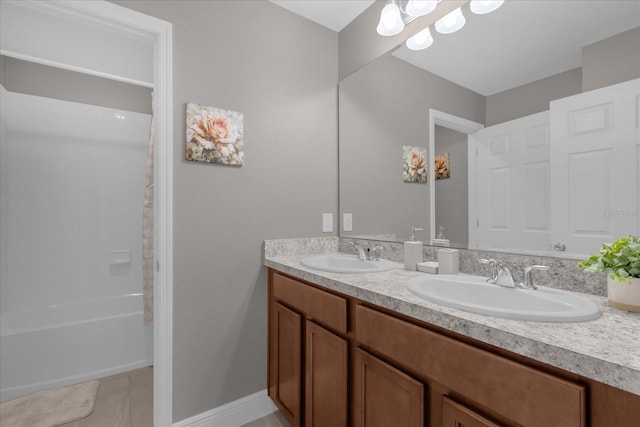 bathroom with tile patterned flooring, vanity, and bathing tub / shower combination