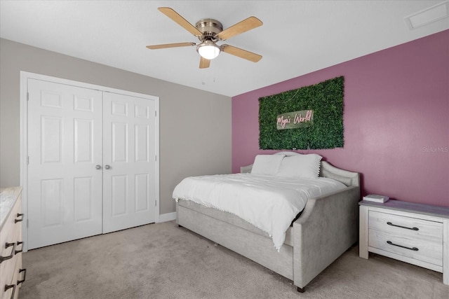 carpeted bedroom featuring a closet and ceiling fan