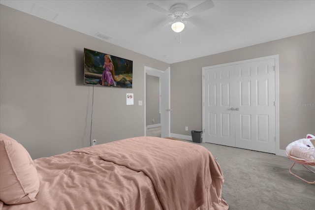 carpeted bedroom featuring ceiling fan and a closet