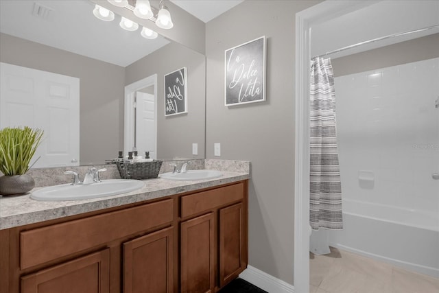 bathroom featuring tile patterned flooring, vanity, and shower / bathtub combination with curtain