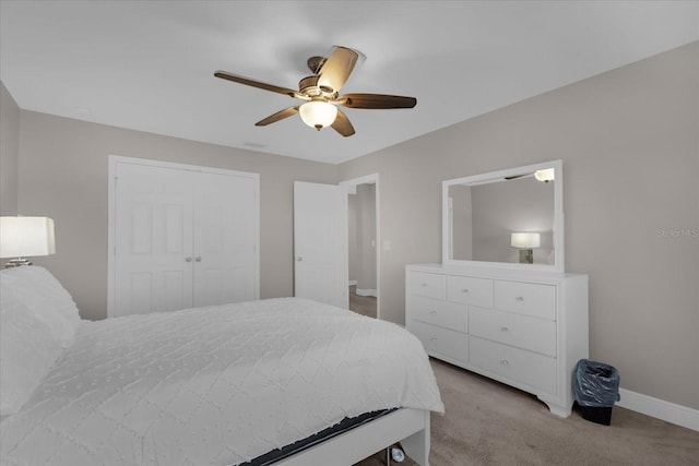 bedroom with a closet, light colored carpet, and ceiling fan