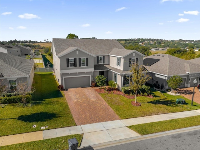 view of front of home featuring a garage and a front lawn