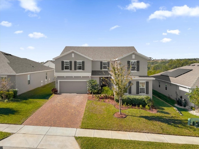 front of property with a front lawn and a garage