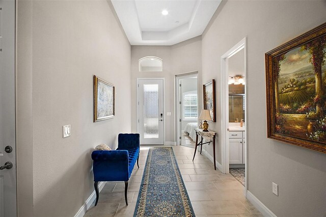 entryway featuring light tile patterned floors and baseboards