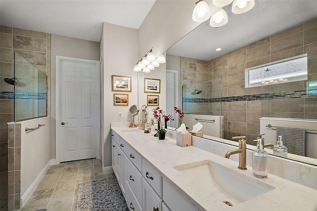 full bath featuring a walk in shower, double vanity, a sink, and baseboards