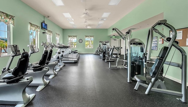 workout area featuring ceiling fan and baseboards