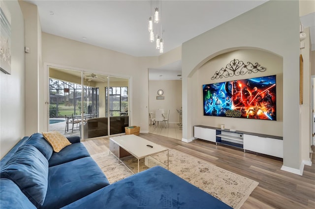 living room with ceiling fan and wood-type flooring