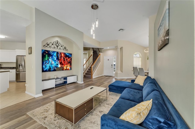 living room with light hardwood / wood-style floors and lofted ceiling