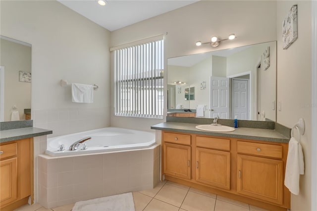 bathroom with vanity, tiled bath, and tile patterned floors