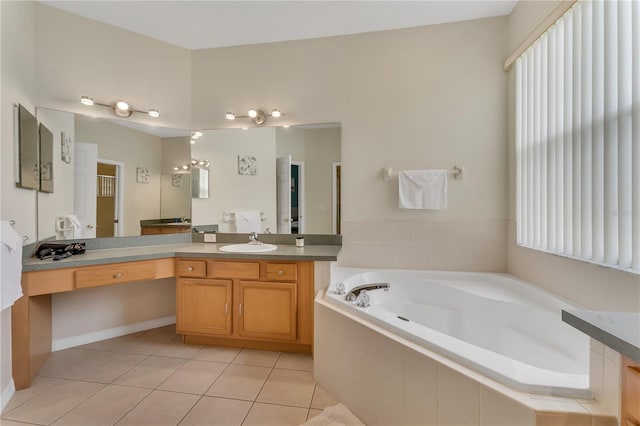 bathroom featuring tiled tub, tile patterned flooring, and vanity