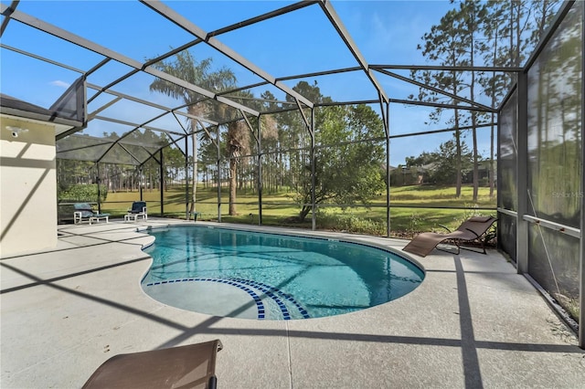 view of pool featuring glass enclosure and a patio