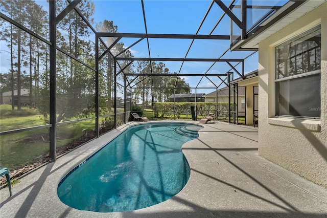 view of pool with a patio and a lanai