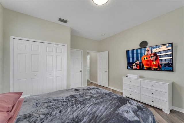 bedroom with light wood-type flooring and a closet