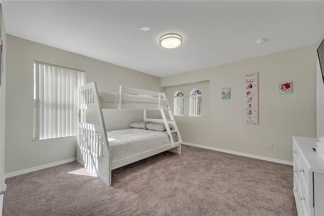 unfurnished bedroom with light carpet and multiple windows