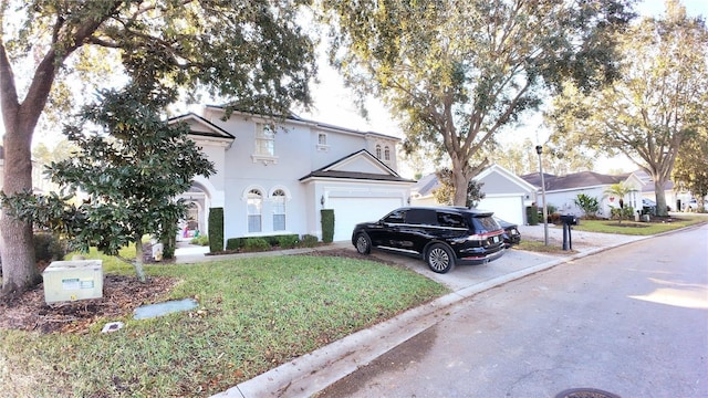 view of front of property featuring a front yard and a garage