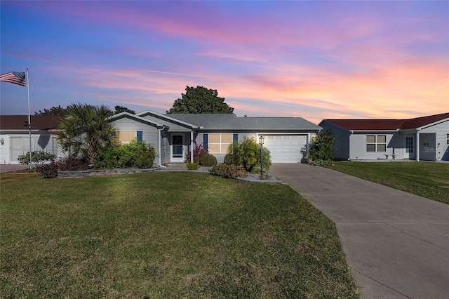 single story home with a lawn and a garage