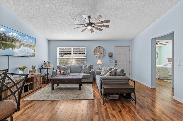 living room with dark wood-type flooring and a textured ceiling