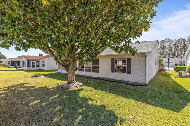 view of front of home featuring central AC unit and a front lawn