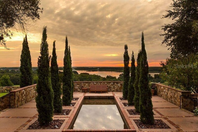 patio terrace at dusk with a water view