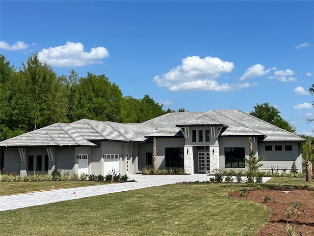 prairie-style house with stucco siding and a front lawn