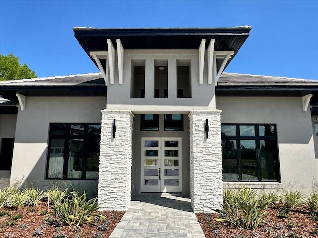 entrance to property featuring stucco siding