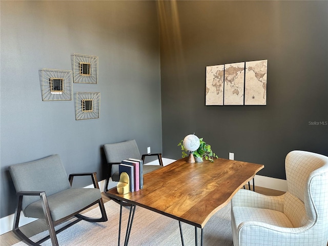 home office with baseboards and light wood-style flooring